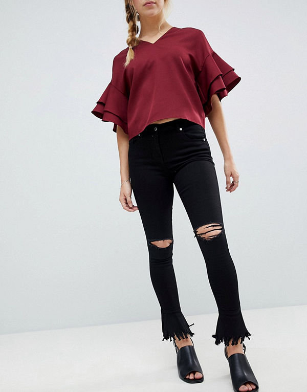 Parisian Skinny jeans med revor i knän och sliten utsvängd nederkant